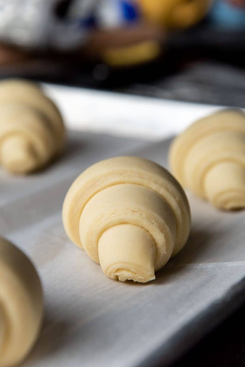 A proofed croissant on a baking tray