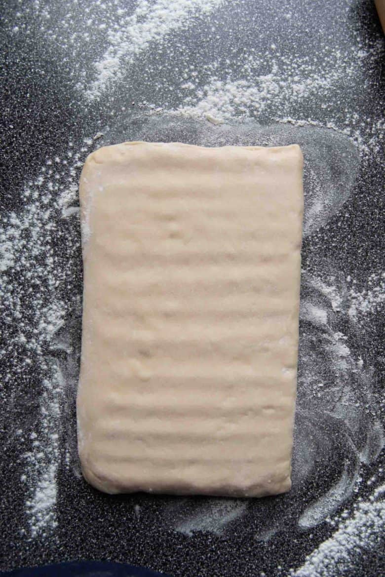 A view of what the dough looks like after tapping the dough with the rolling pin.