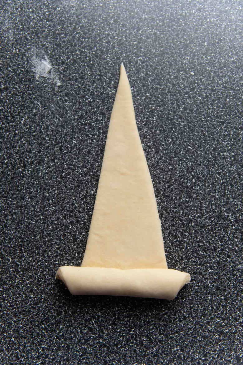 An overhead view of the croissant being rolled up