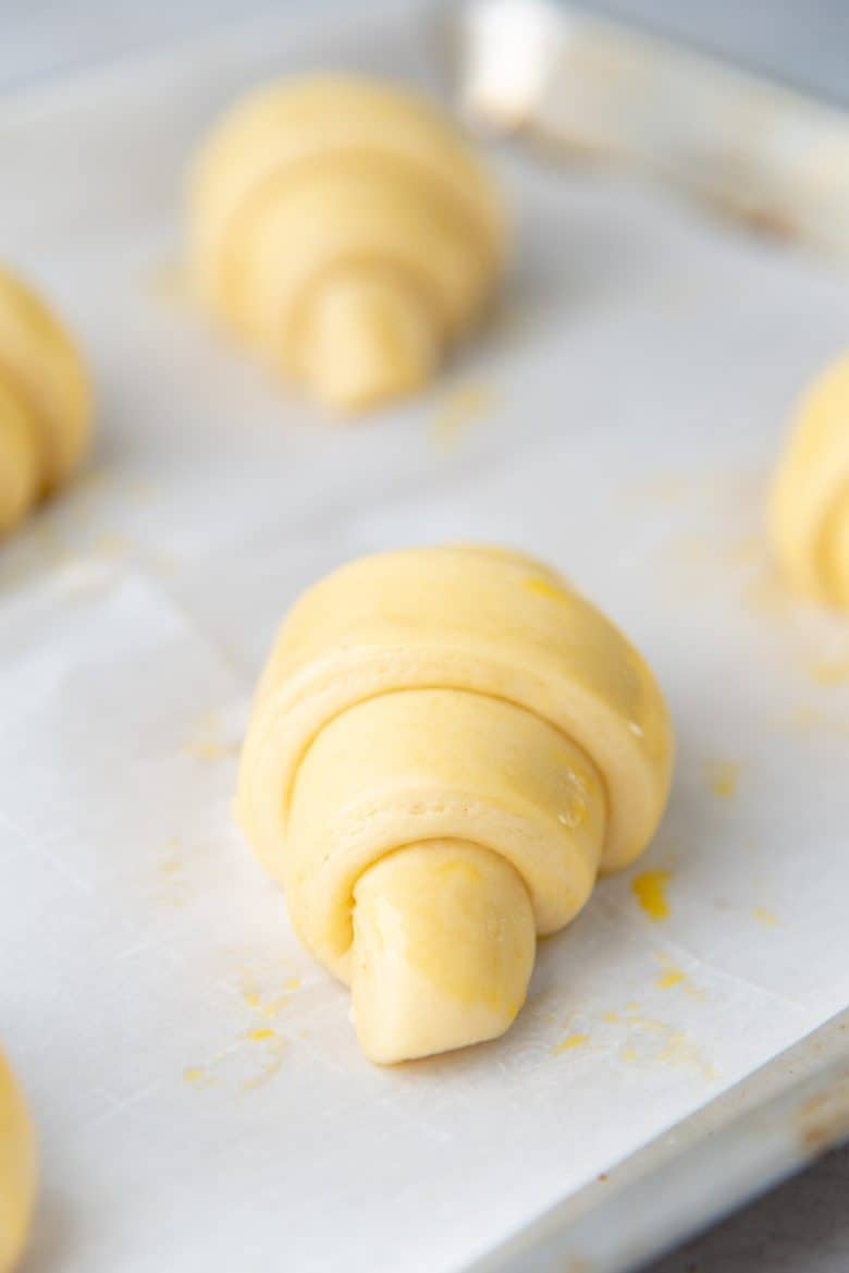 A proofed croissant egg washed on the surface