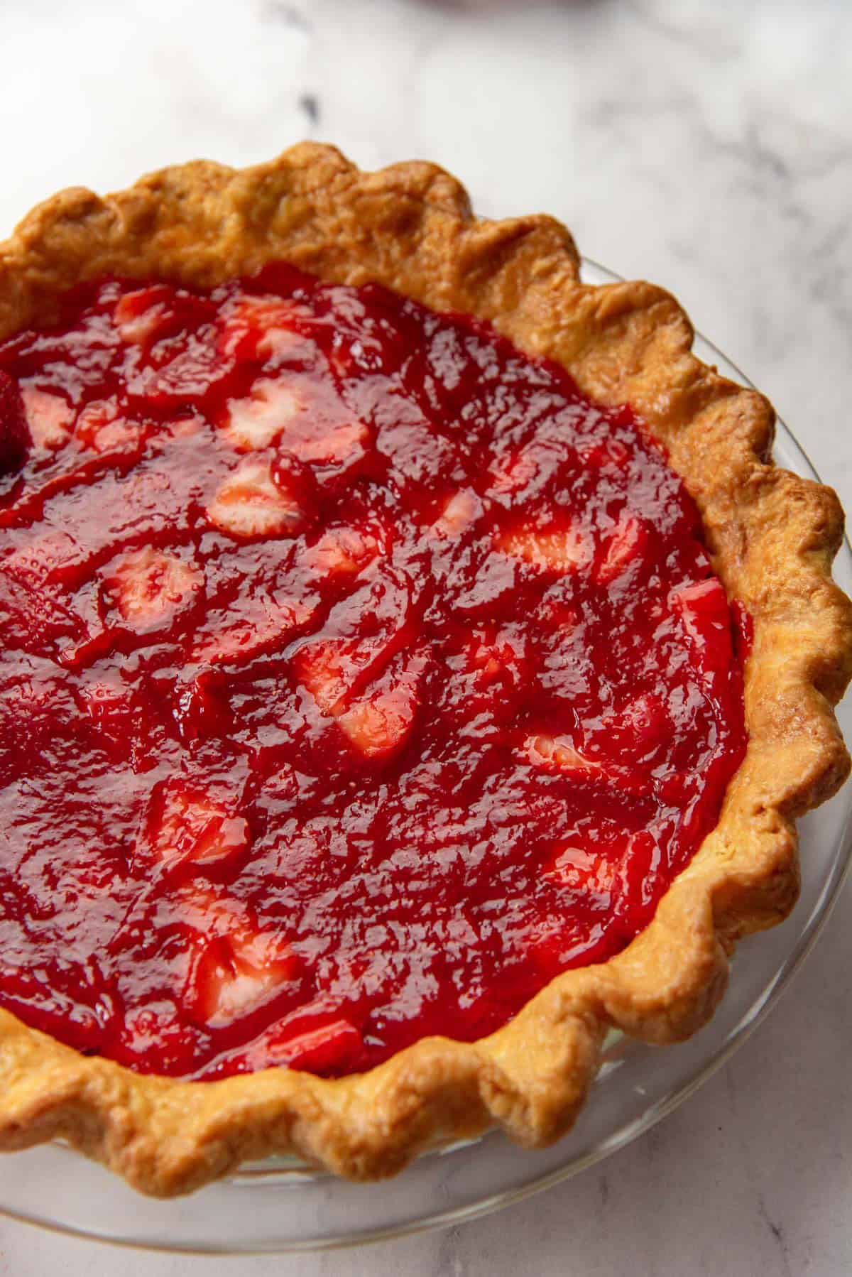 Fresh strawberry pie filling spread inside a blind baked pie crust.