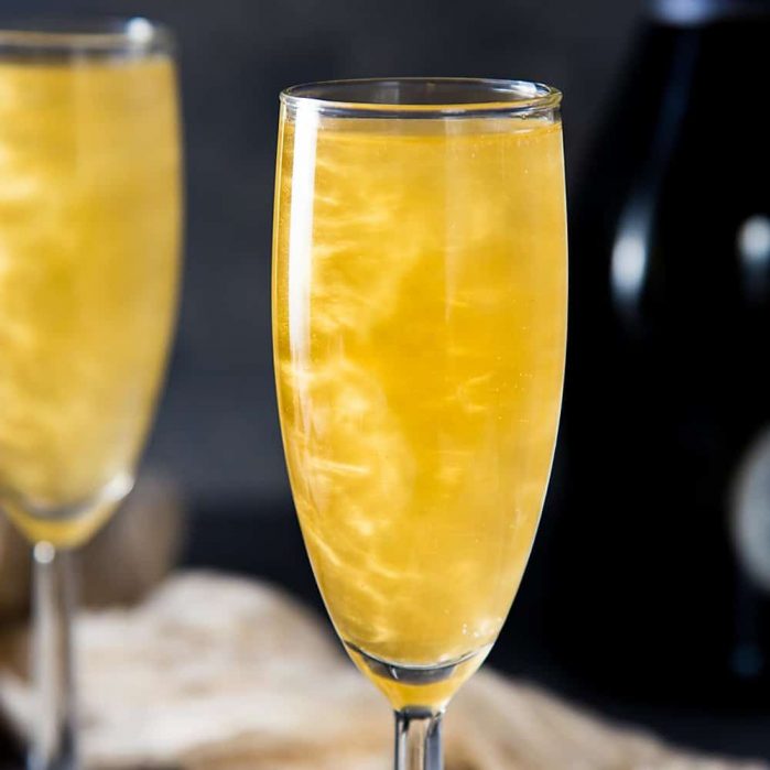 Gold Shimmery Champagne Cocktail - an easy shimmery New Year's Eve Cocktail that is perfect as any celebration cocktail. Get the recipe for this floral and bubbly, elderflower champagne cocktail with non alcoholic options too. 