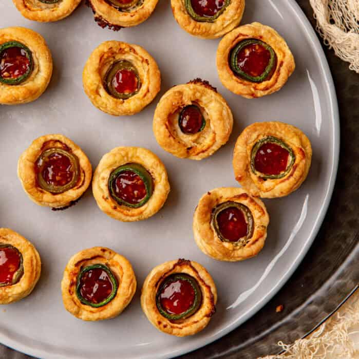 Jalapeno eye ball appetizers arranged on a plate.