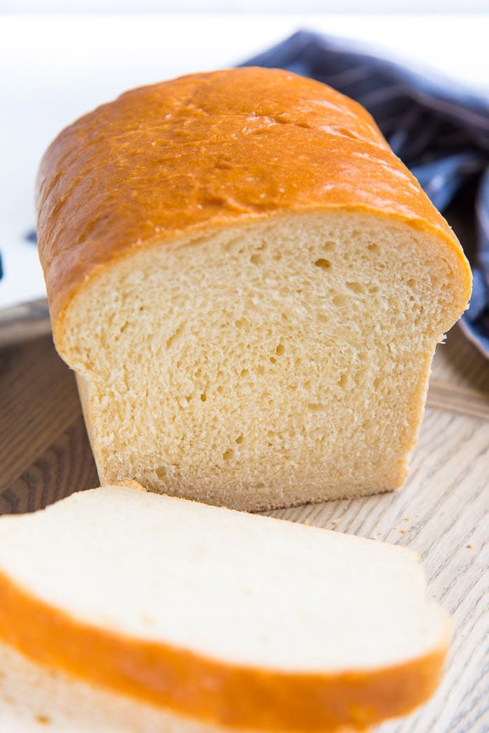 Best homemade bread loaf on a cutting board, with slices cut from it.