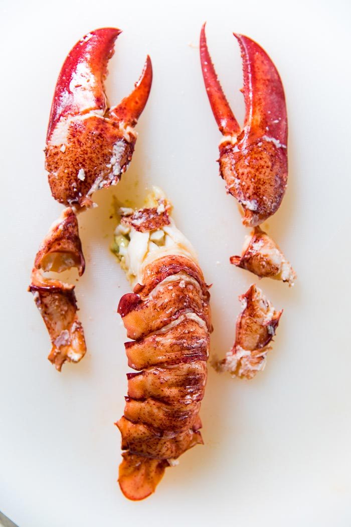 All the lobster meat from 1 whole lobster placed on a white cutting board.