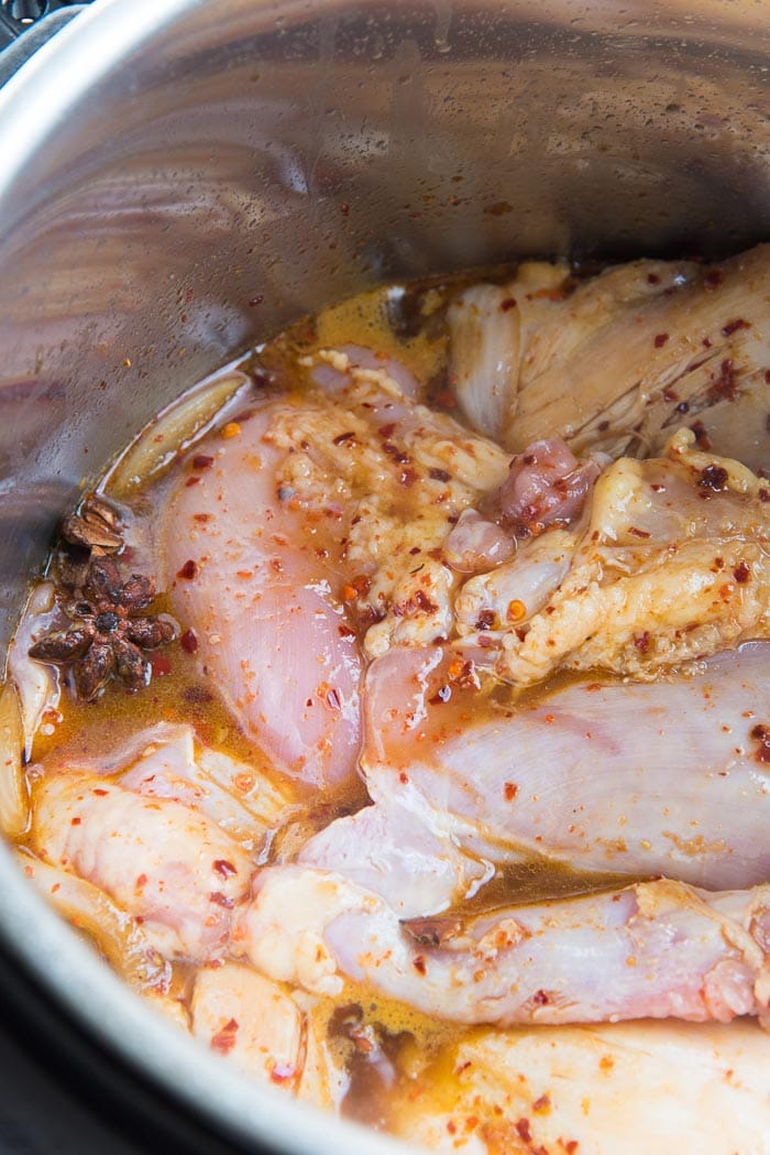 The Chicken mixed in with the honey soy marinade inside the instant pot.