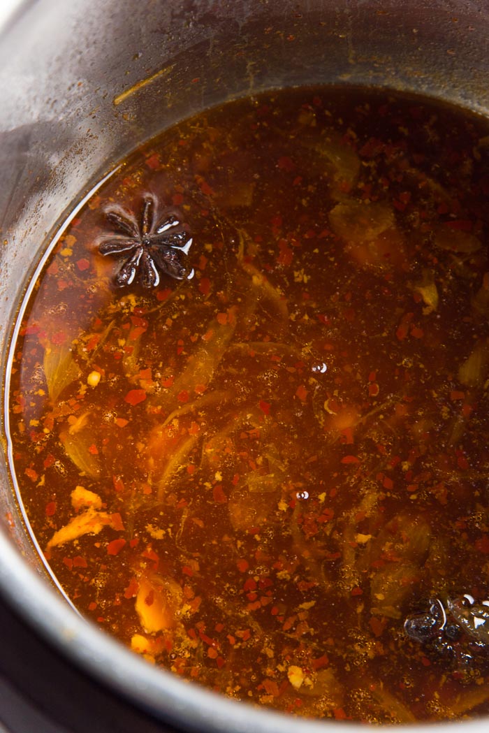 The leftover liquid inside the instant pot, after cooking the asian flavored chicken thighs.