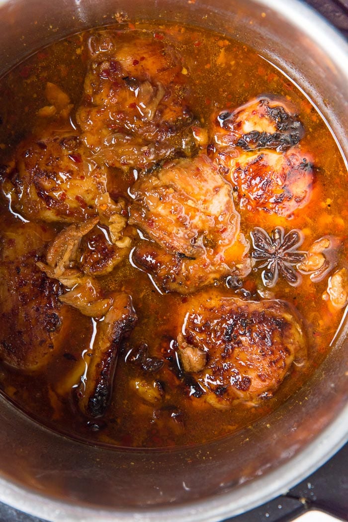 Instant pot honey soy chicken after being caramelized, sitting inside the pot with the sauce