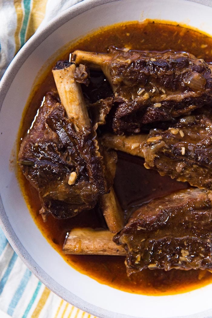 These instant pot short ribs (or Pressure cooker short ribs) have been cooked and places in a serving dish. 