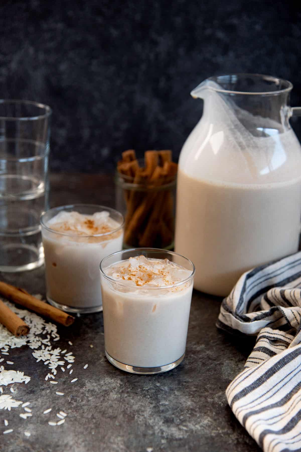 Serving Mexican horchata in a glass with a sprinkling of cinnamon on top.