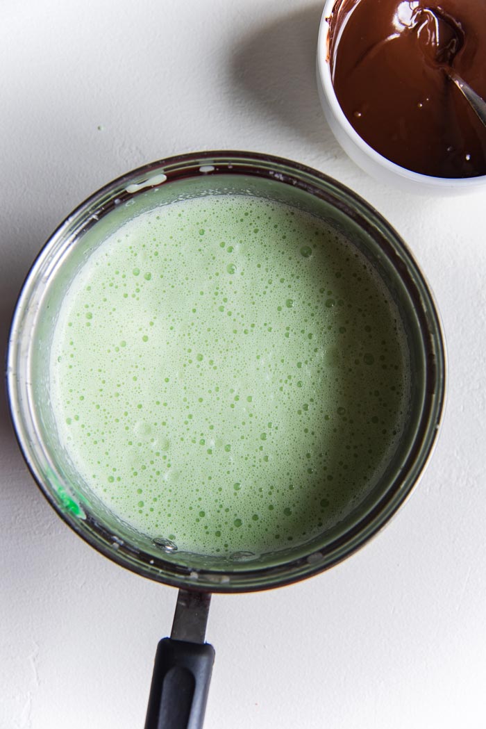Chilled Mint ice cream base after coloring it green, in a saucepan ready to be churned. 
