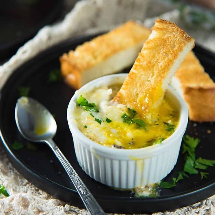 Creamy Gruyere and Mushroom Eggs en Cocotte - incredibly simple breakfast or brunch dish to prepare, but fancier and more flavorful than you could imagine! Baked eggs with a creamy spiced mushroom sauce and gruyere cheese.