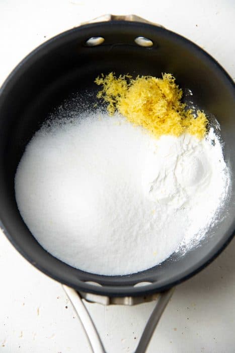 Sugar, cornstarch and lemon zest for lemon curd in a saucepan