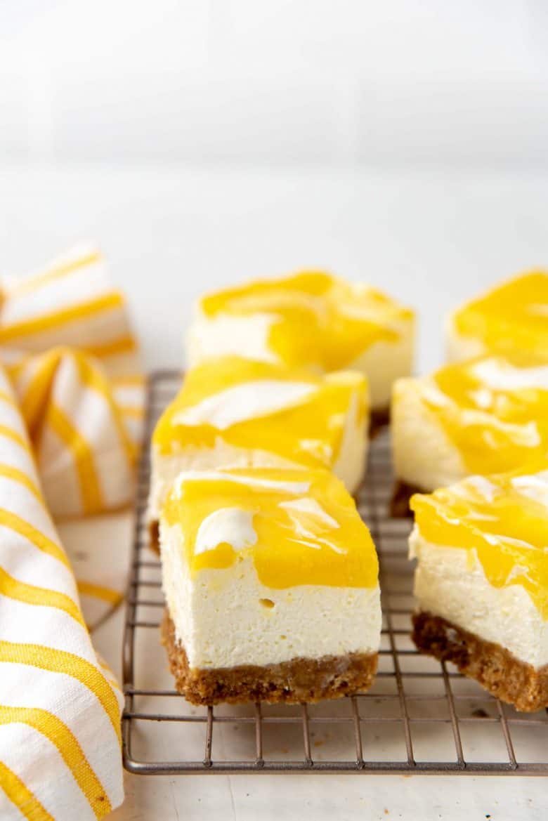 The lemon cheesecake bars on a wire rack