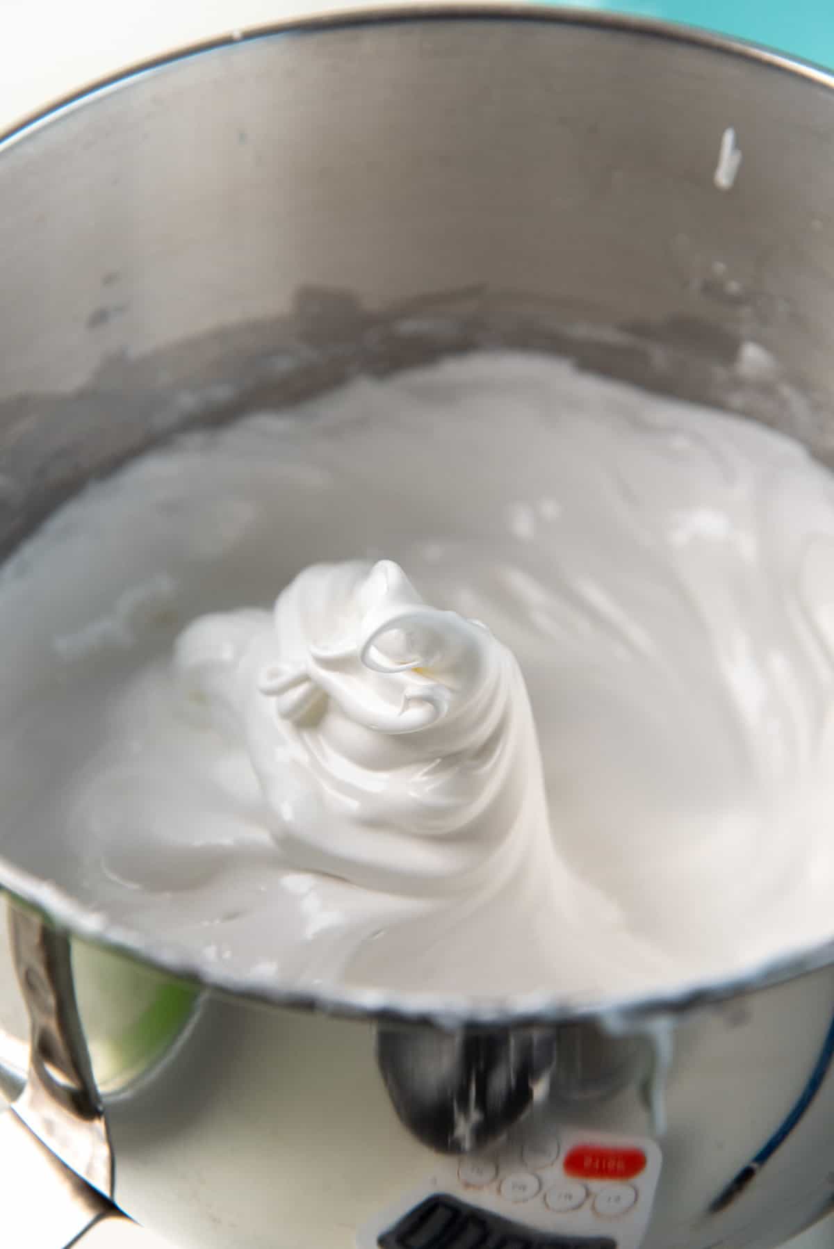 A close up of the meringue for the pavlova, inside the mixer bowl, after forming stiff peaks.