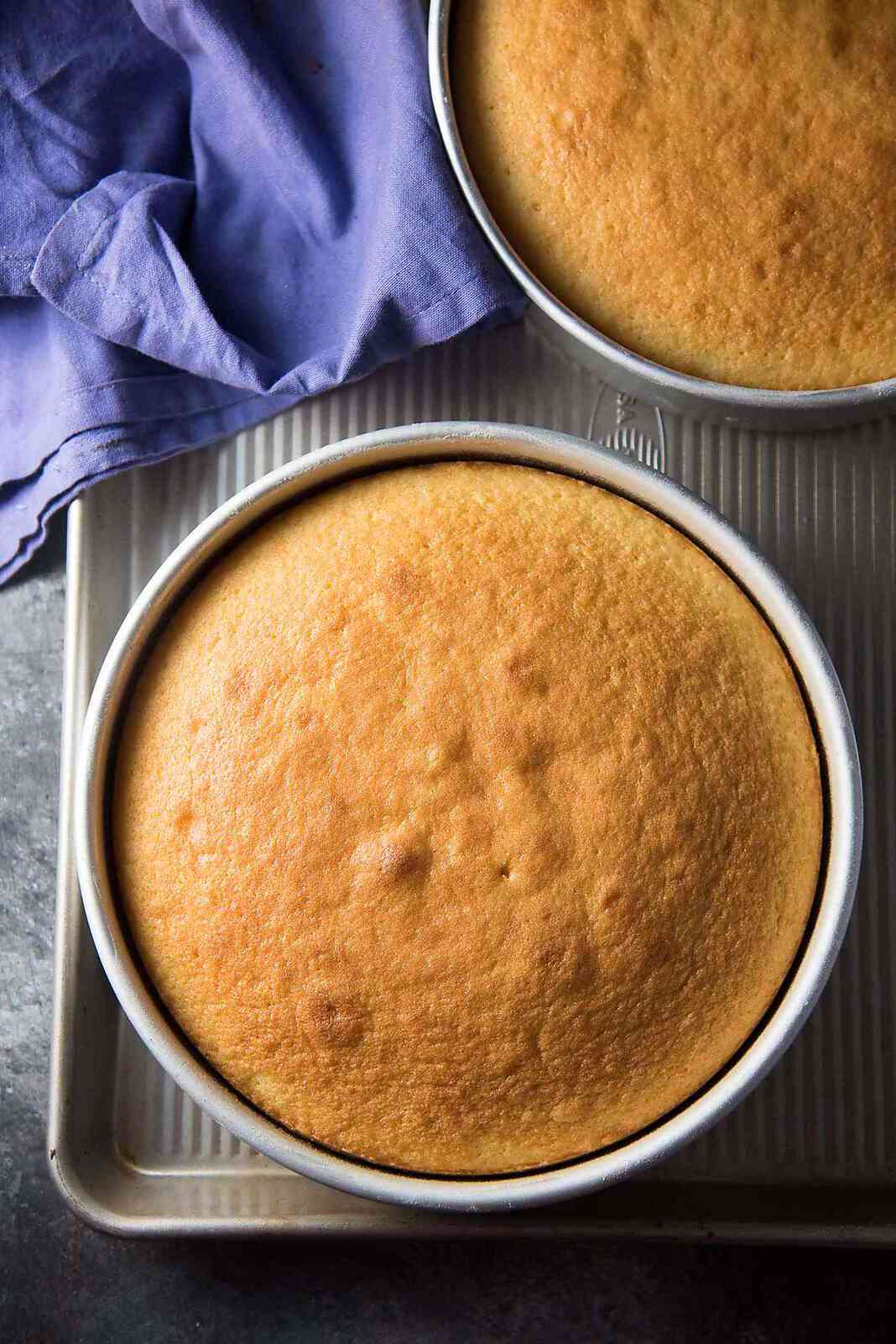 The Best Vanilla Cake - two vanilla cake layers baked and cooling. It's important to let them cool before frosting. 