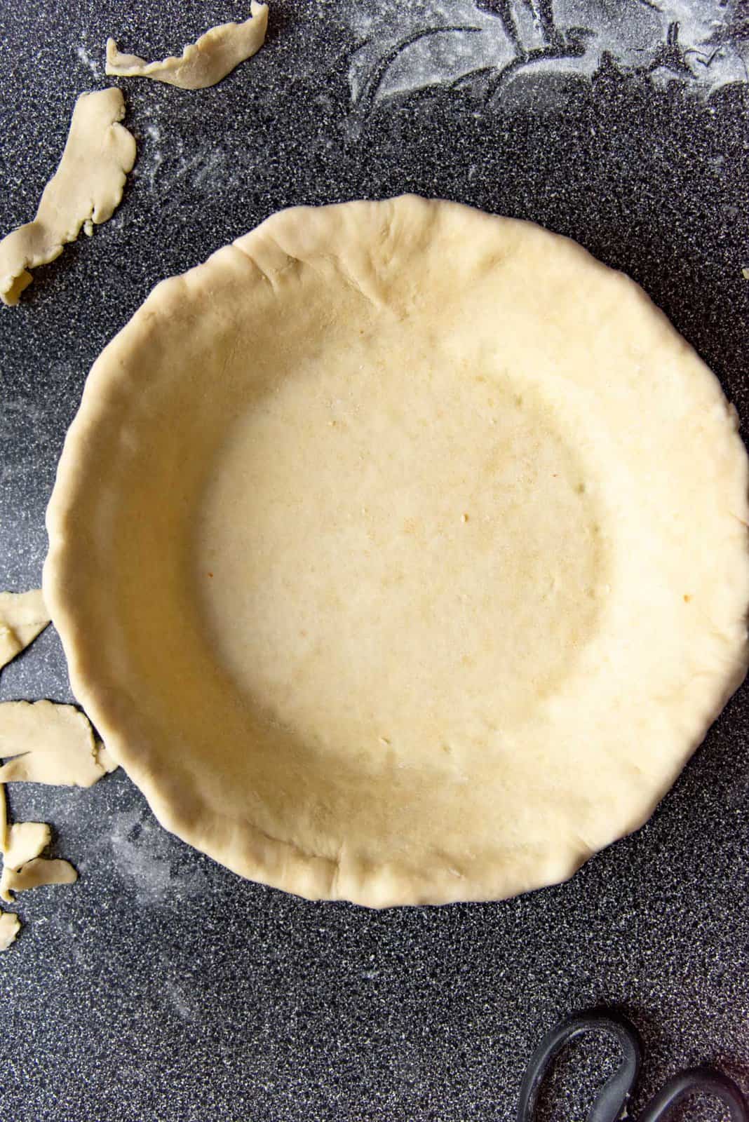 Overhead view of the pie plate after the edges were rolled under to form the crust.