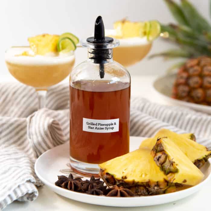 A square image of the grilled pineapple syrup in a bottle.