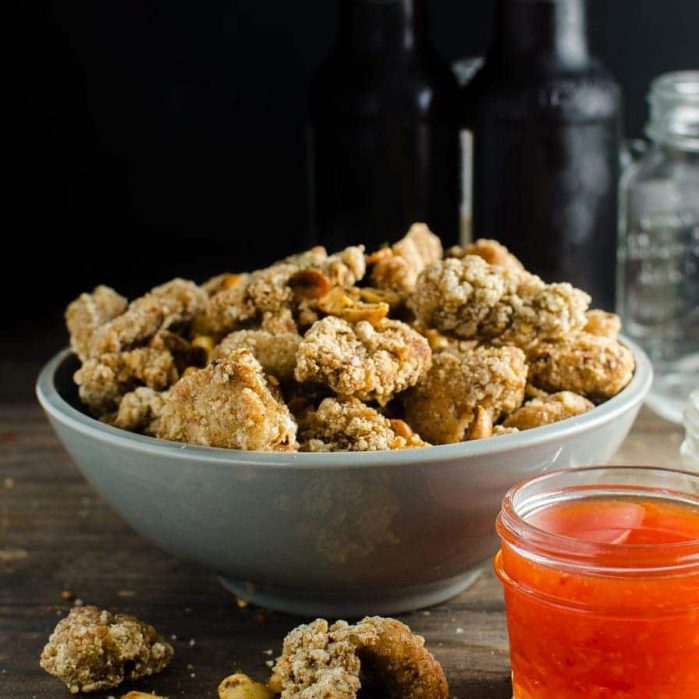 Spicy Cumin Popcorn Chicken - Deliciously marinated, crispy popcorn chicken bites, tossed with spicy cumin salt and toasted peanuts, this is the PERFECT party and game day appetizer!