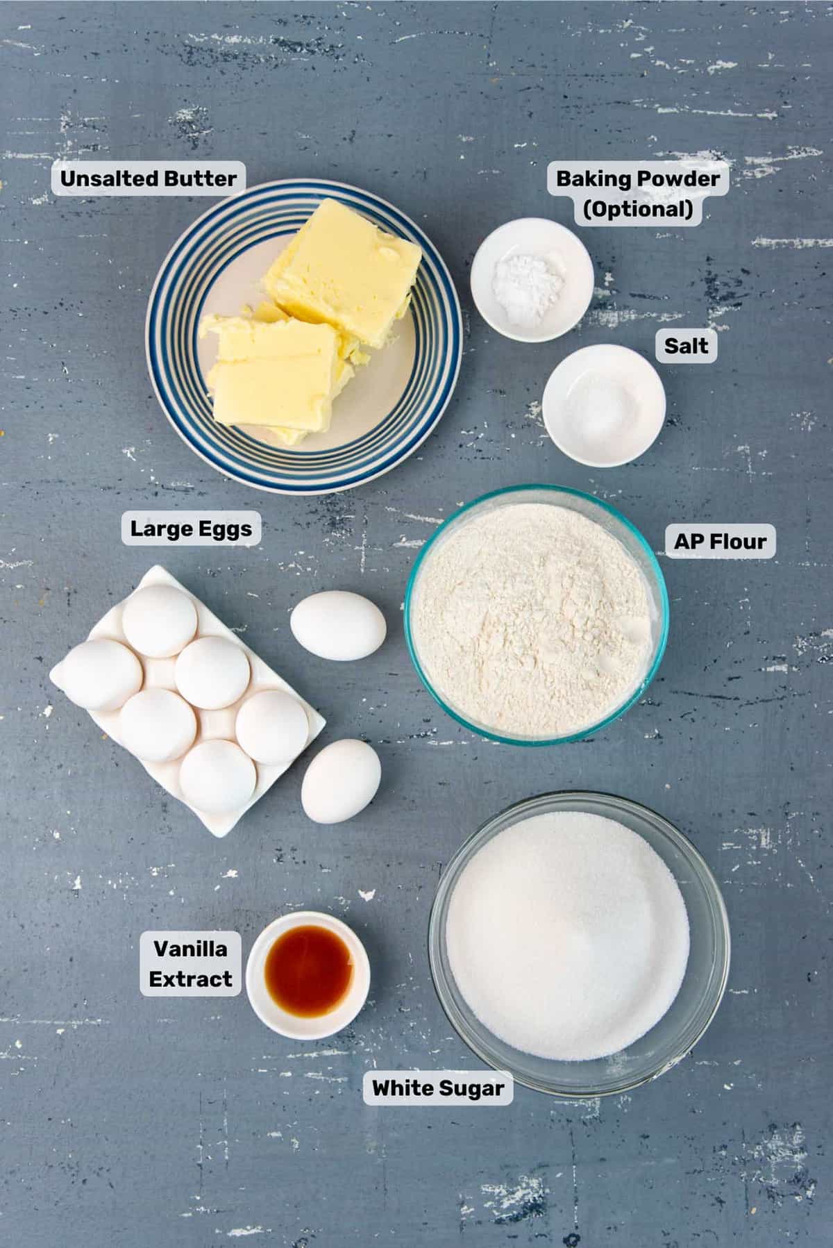 Ingredients needed to make pound cake in separate bowls.
