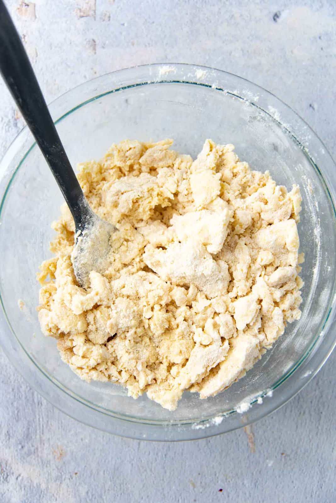 Clumps of flour and butter while mixing with spatula.