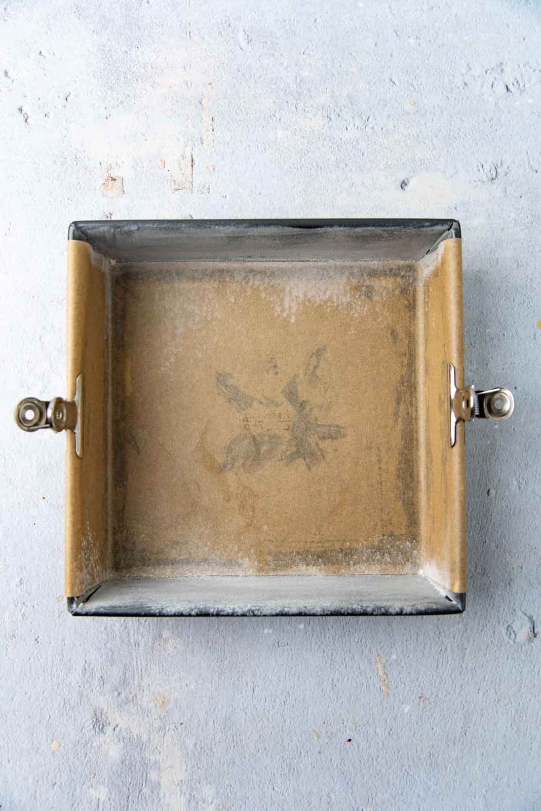 Baking pan prepared with parchment paper.