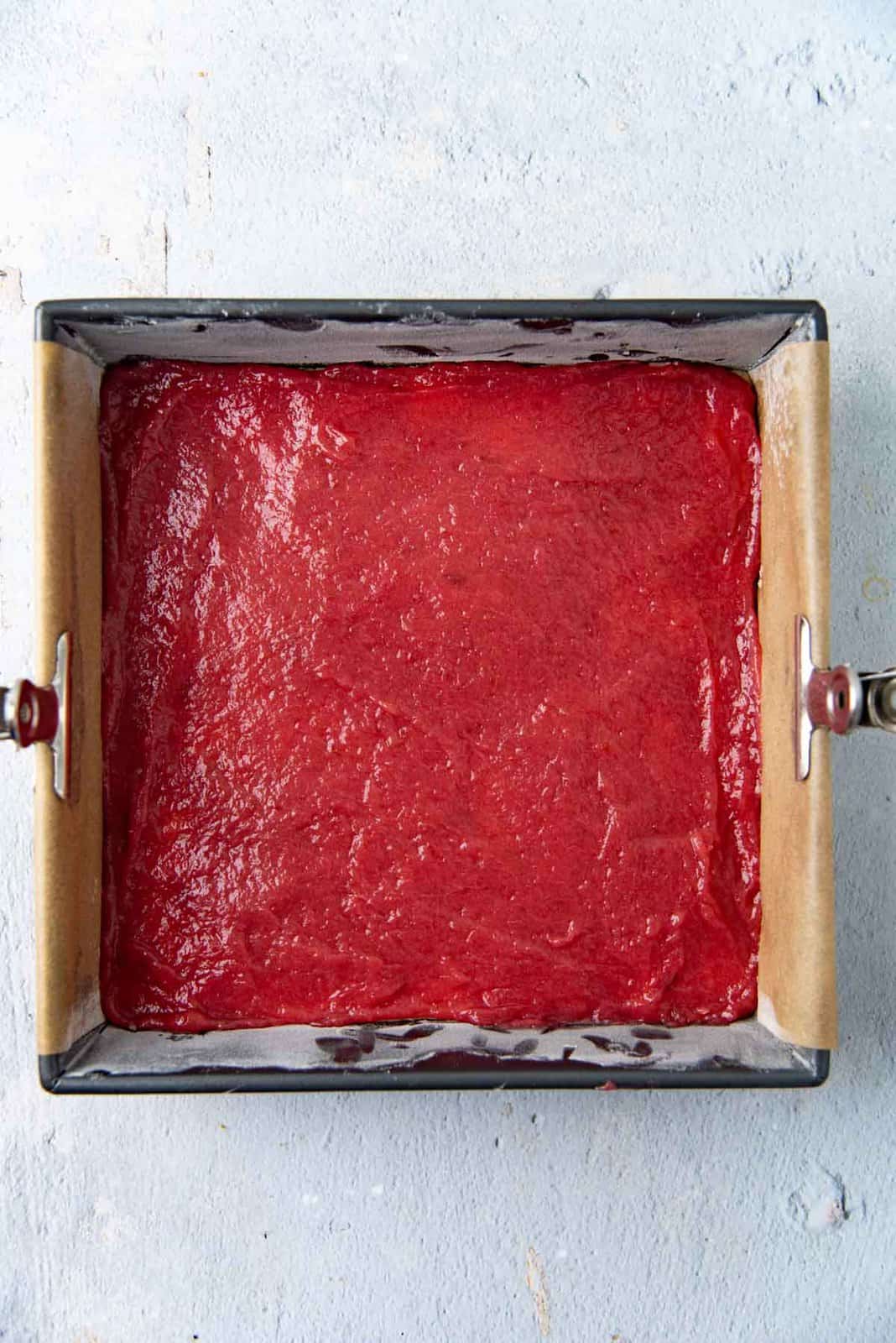 The rhubarb jam filling spread over the base.