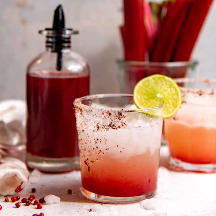 An ombre rhubarb margarita in a glass, square image.