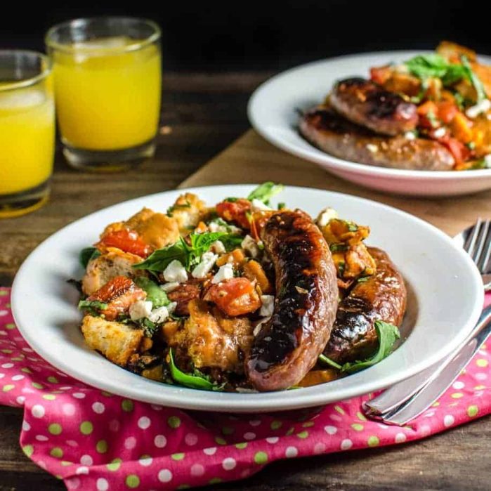 Roasted Panzanella Salad with a Balsamic Honey Mustard Dressing- with roasted Sausages, Tomatoes, Sweet potatoes, Goat cheese and Herbs is easy to make, and can be eaten warm, or at room temperature! Perfect for winter or any time of the year.
