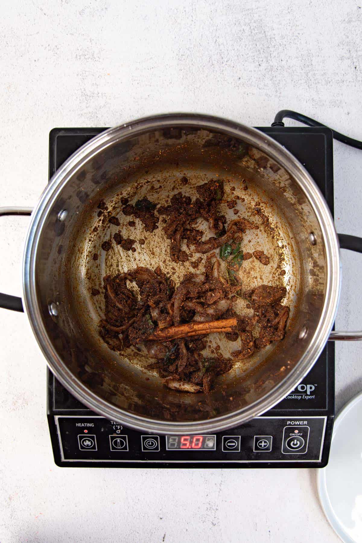 The spices sauteed with the softened onions for the chicken curry base.