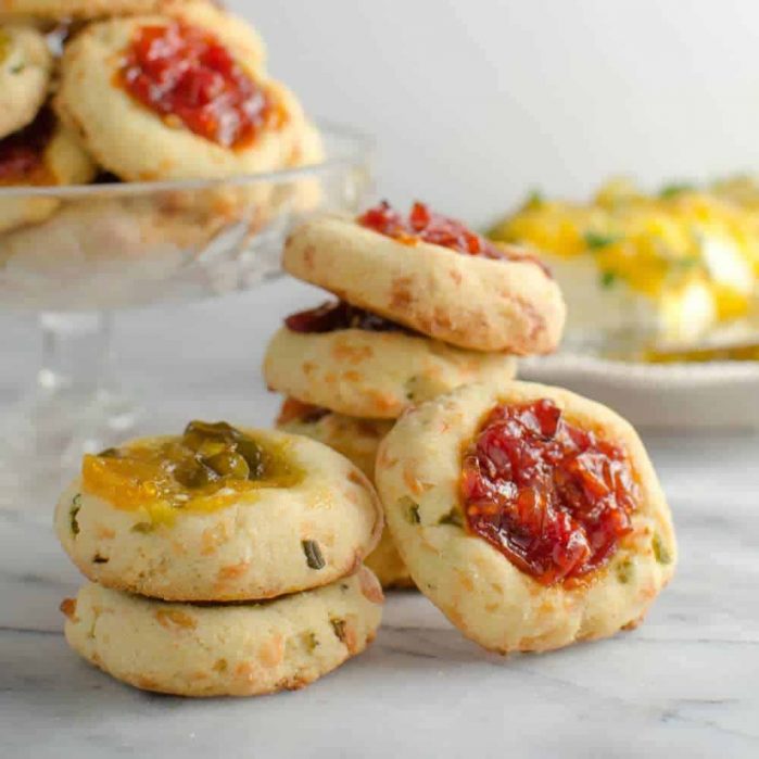 Savory Cheese Thumbprint Cookies with Bourbon Tomato Jam - These savory cookies are the NEXT BEST THING! Buttery, herby cookies with delicious cheddar cheese, and an amazing tomato jam! Comes together easily and its PERFECT as an appetizer, party food, or as a snack!