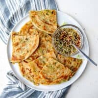 Scallion pancakes on a plate, overhead view. For featured image.