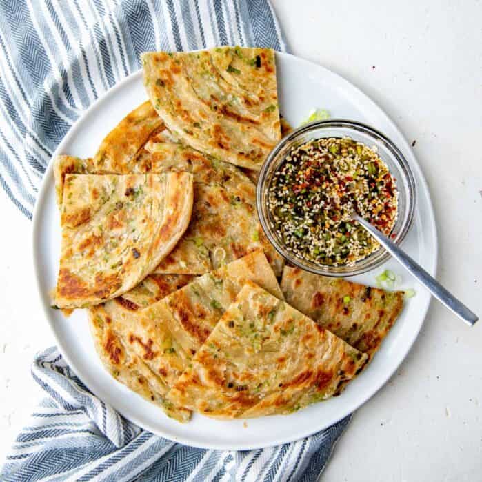 Scallion pancakes on a plate, overhead view. For featured image.