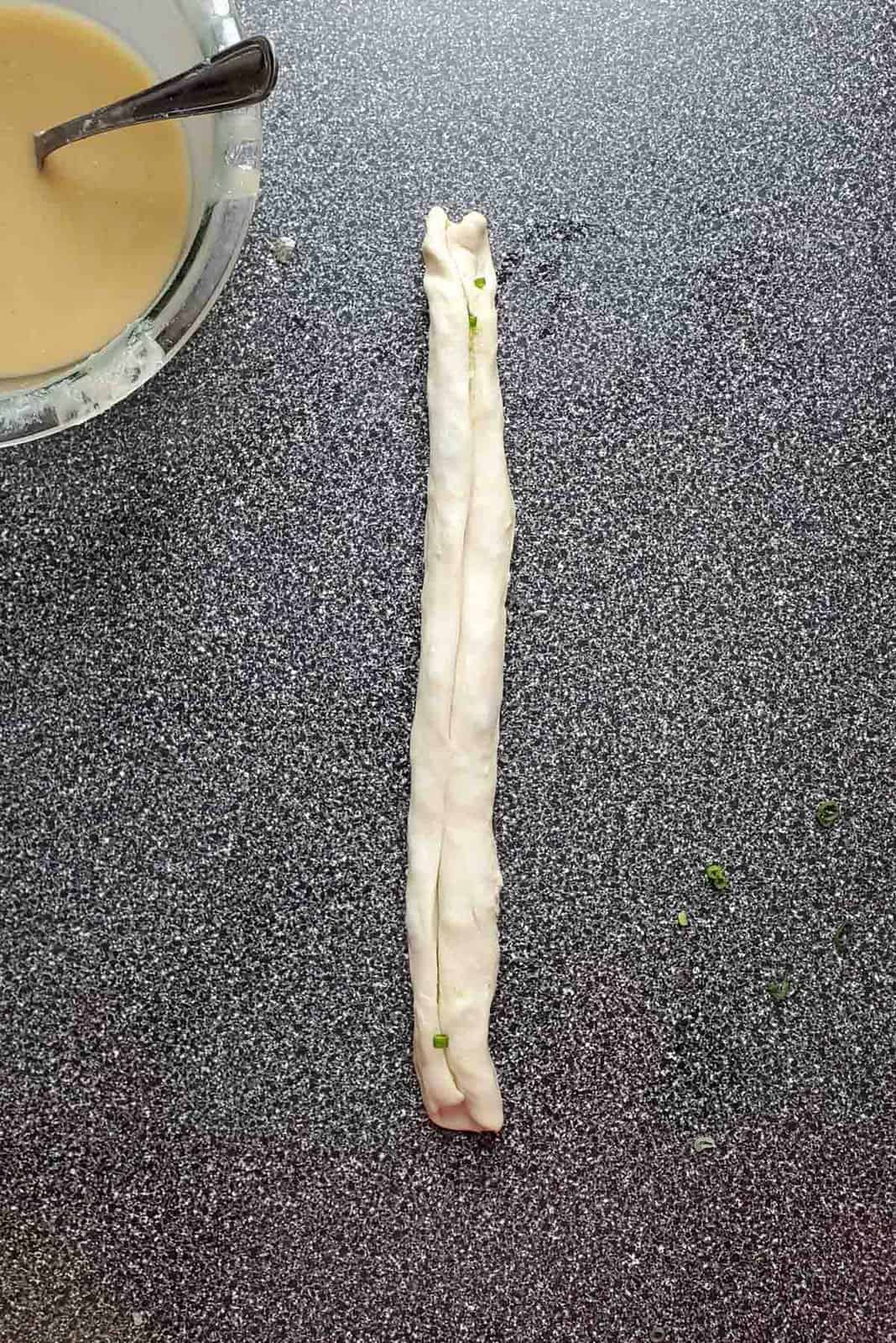 The dough log stretched out.