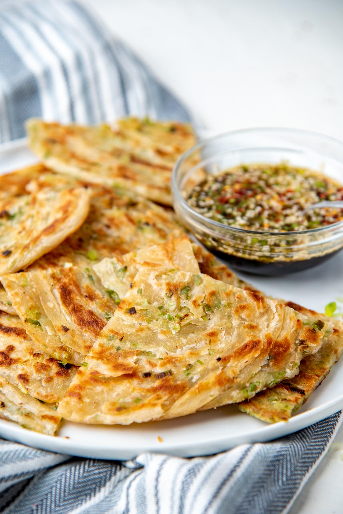 A close up of the flat bread showing the layers with pan fried golden spots.