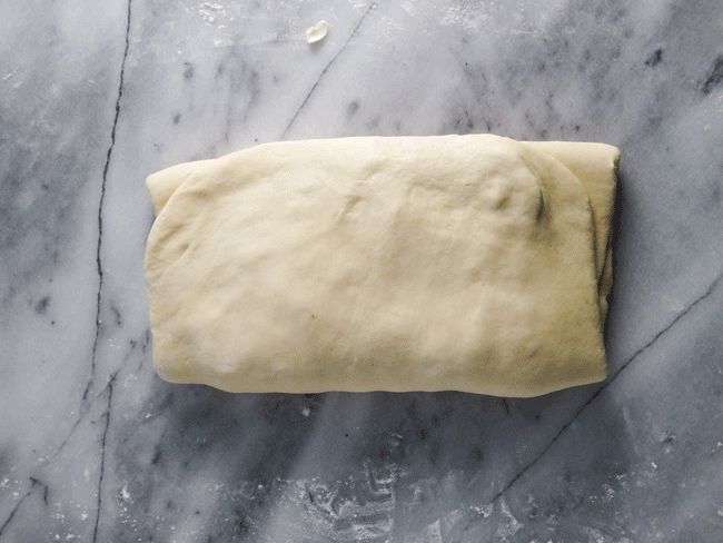 Adding the second half of butter into the dough, for the second lamination and the second fold for rough puff pastry.