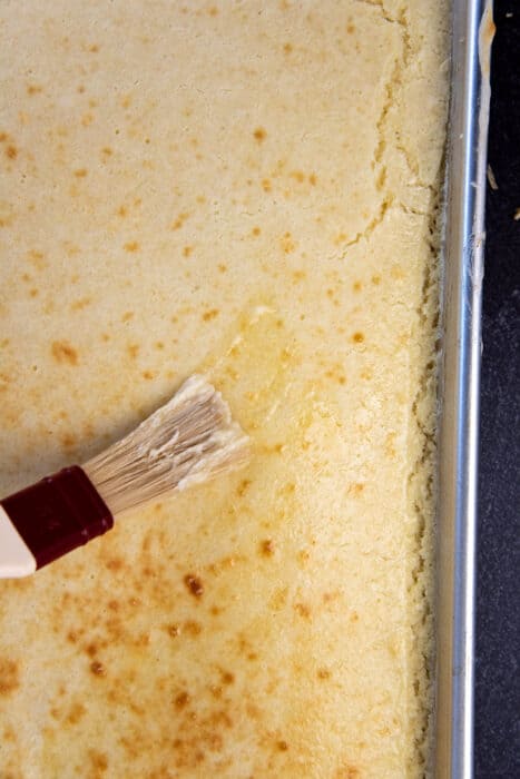 Butter being brushed ontop of the pancake, before being broiled.