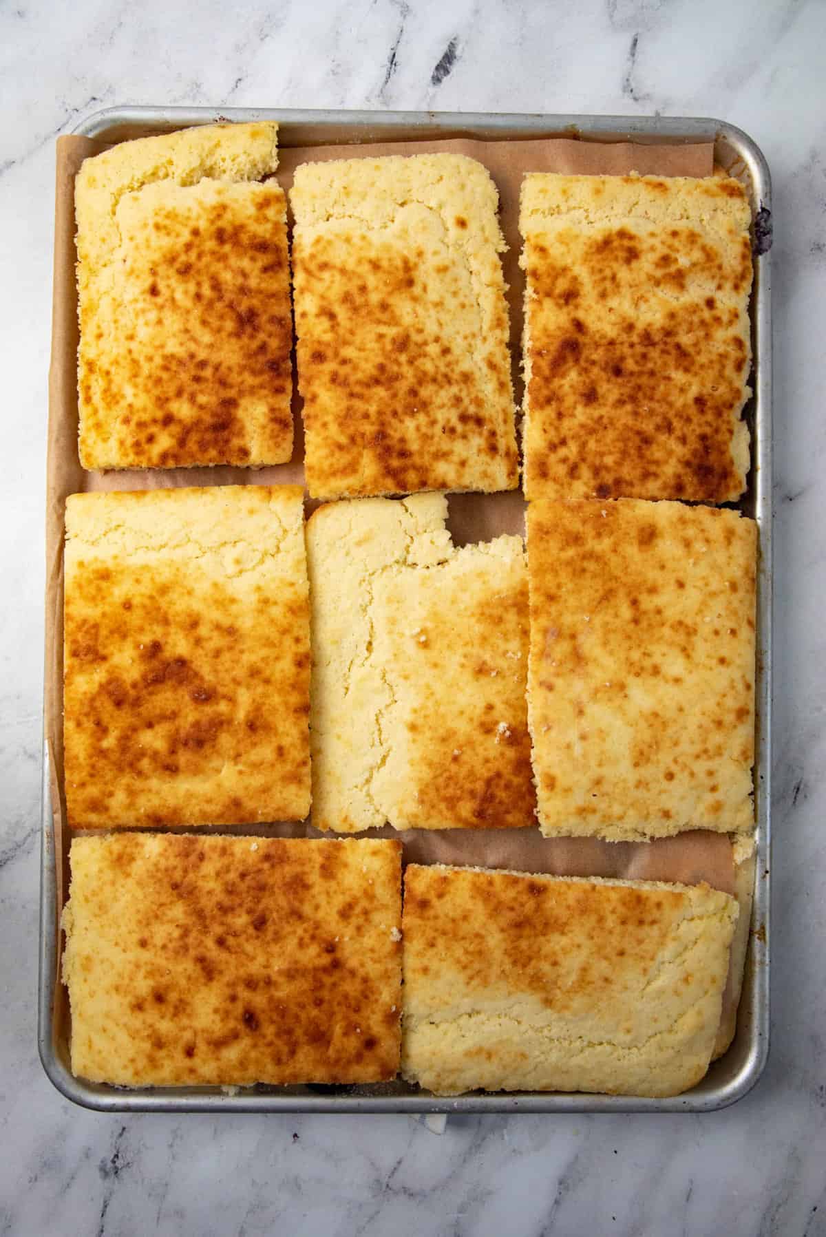 An image of the pancake pieces placed on a lined half sheet pan for freezing.