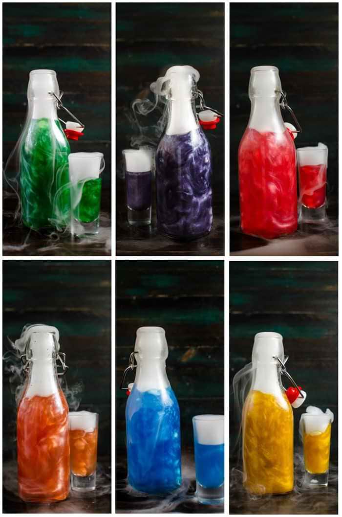 Collage of brightly colored shimmering liqueur in bottles with dry ice induced smoke coming from the tops.