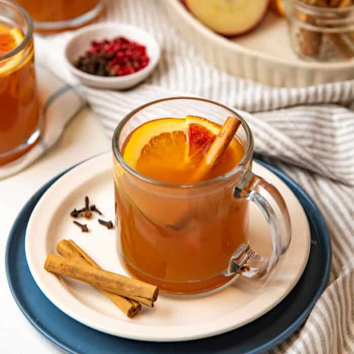 Featured image of spiced apple cider in a glass jug.