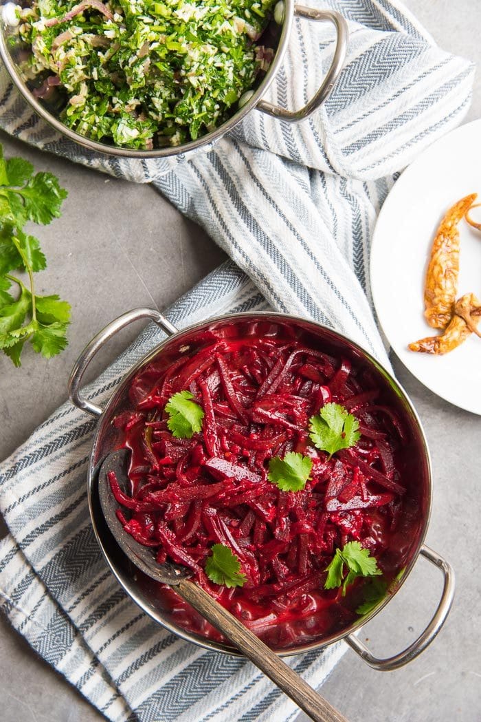 Sri Lankan Beetroot curry made with coconut milk served in a bowl, with a bowl of mallung in a separate bowl.