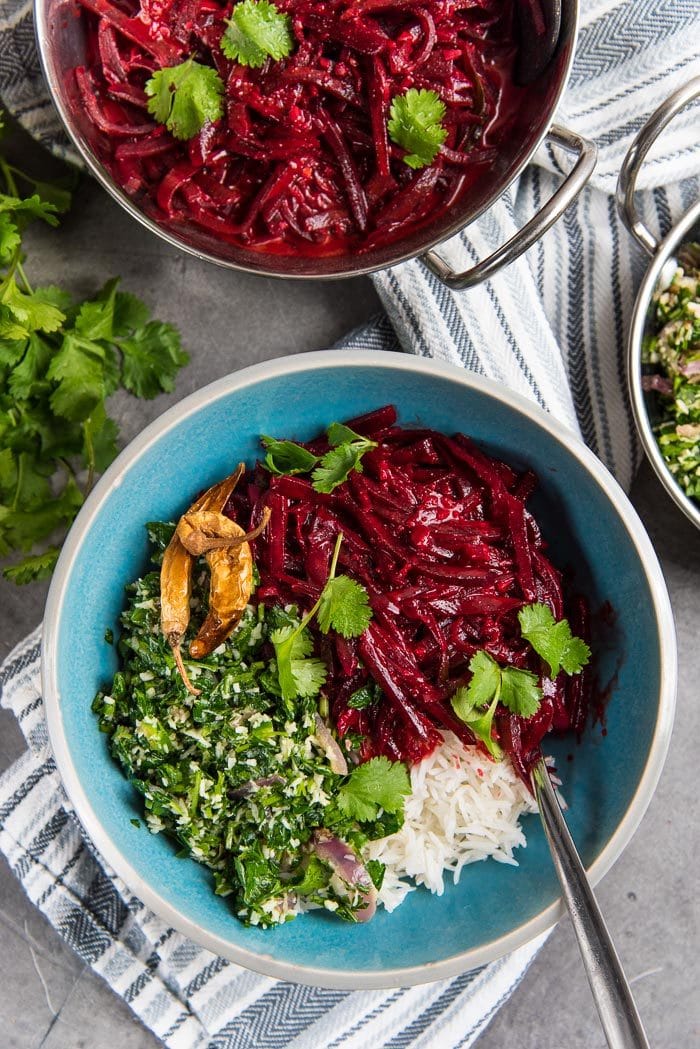 Sri Lankan beetroot curry served on top of a bowl of steamed rice with Parsley mallung and dried chili.