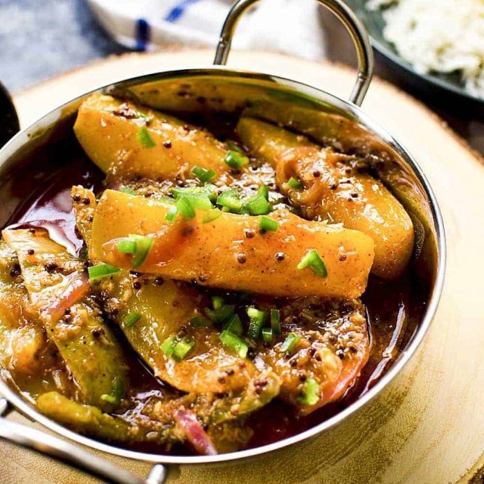 Cooked Sri Lankan mango curry with gravy in a stainless steel saucepan.