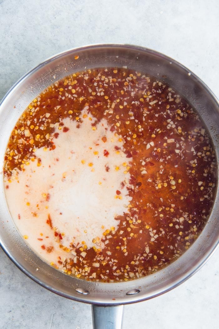 Making Sweet Chili Sauce - Once you have made the sweet chili sauce the cornstarch slurry is added to thicken the sauce.