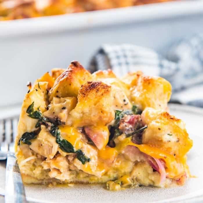 Thanksgiving Leftover Strata - Transform all your thanksgiving leftovers into this layered casserole with pockets of gooey cheese, cranberry sauce, turkey, french toast filling and gravy soaked croutons on top!