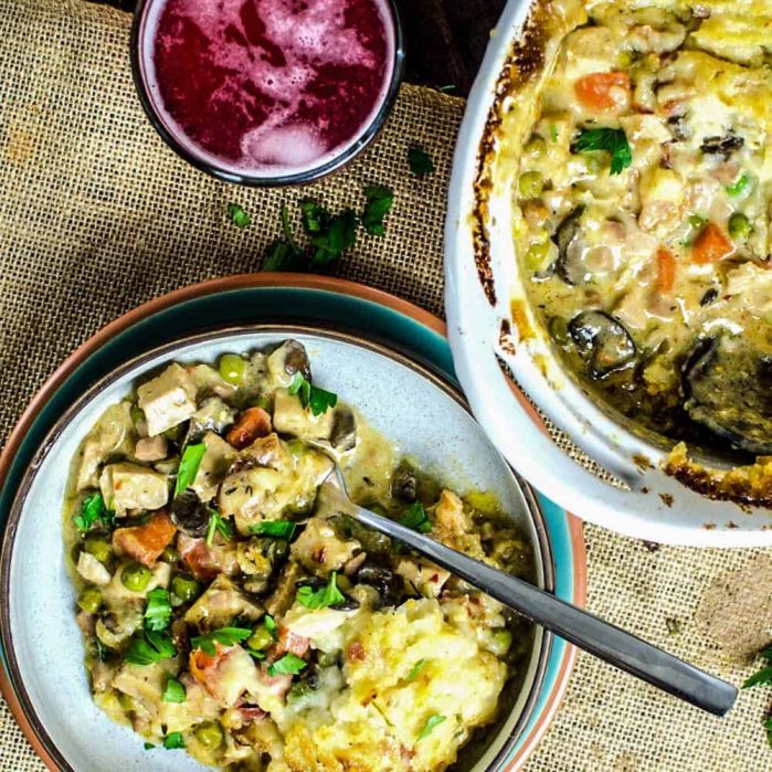 Creamy turkey shepherd's pot pie in a big white bowl, and another portion served in a smaller bowl.