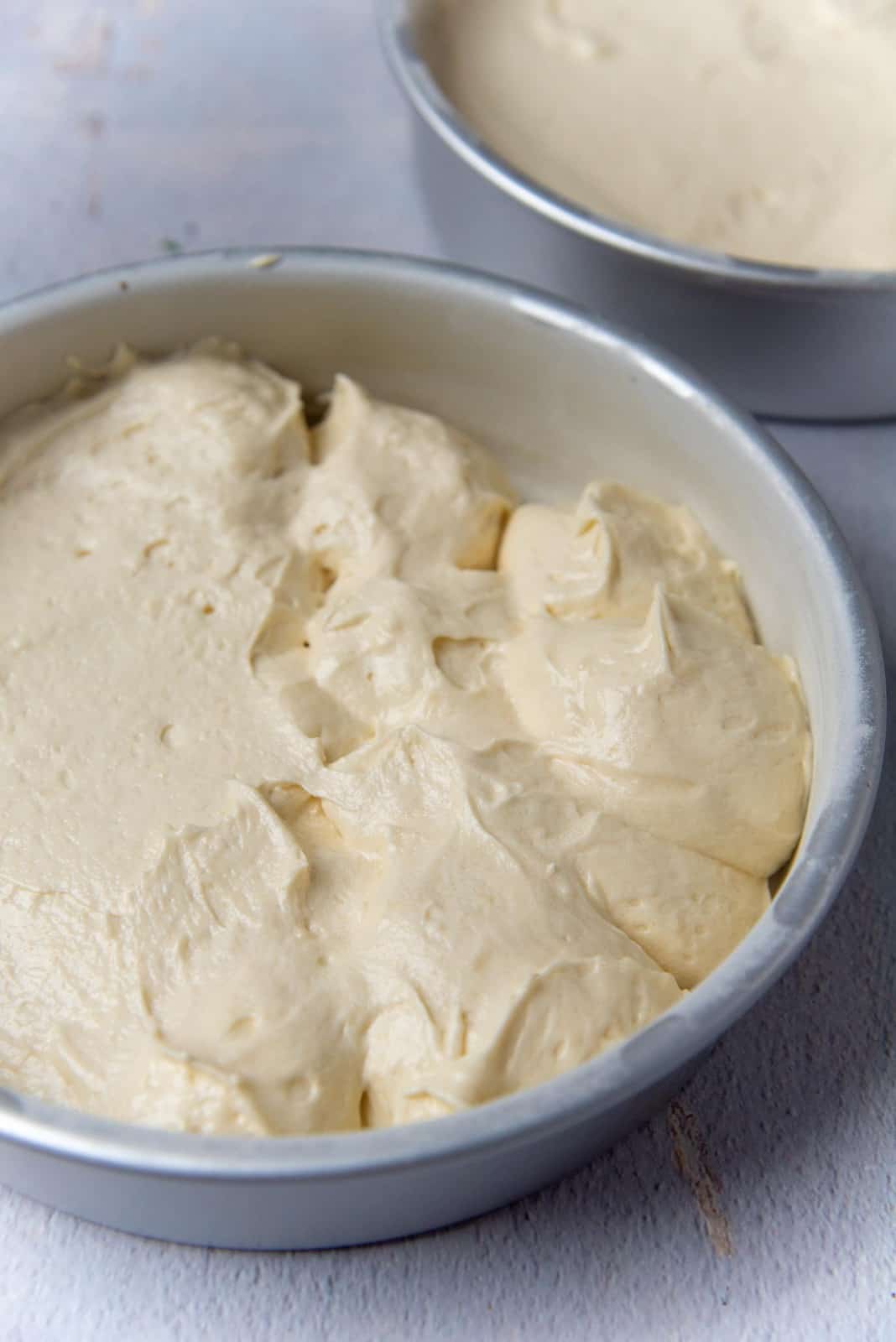 Cake batter divided into cake pans