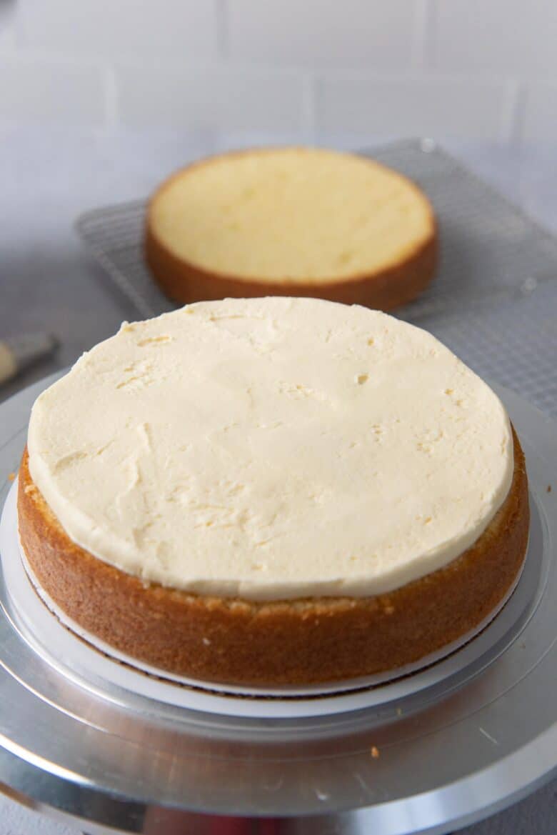 The buttercream spread evenly on the cake layer