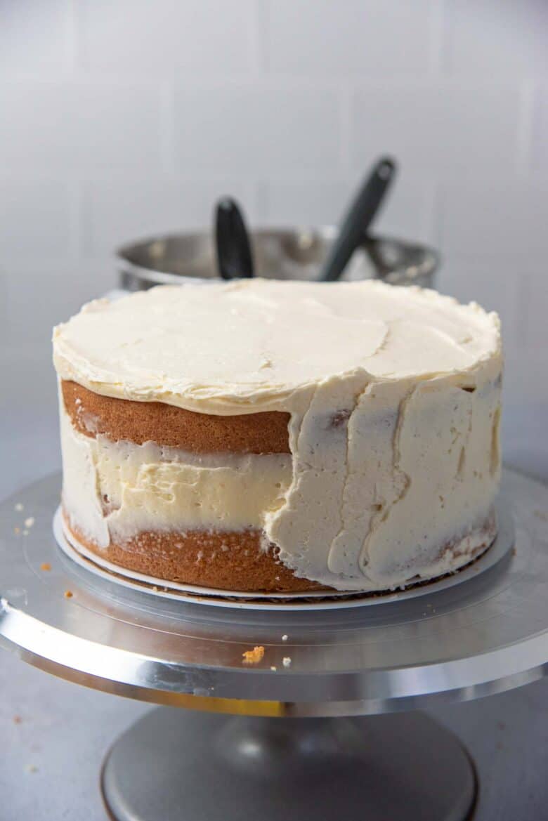 A crumb coating covering half of the cake